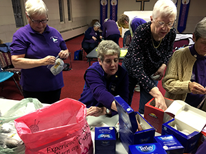 1st Hunter Trefoil Guild packing tea boxes for donation to local food banks.
