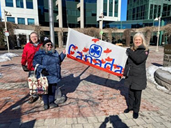 Holding the Girl Guides of Canada flag