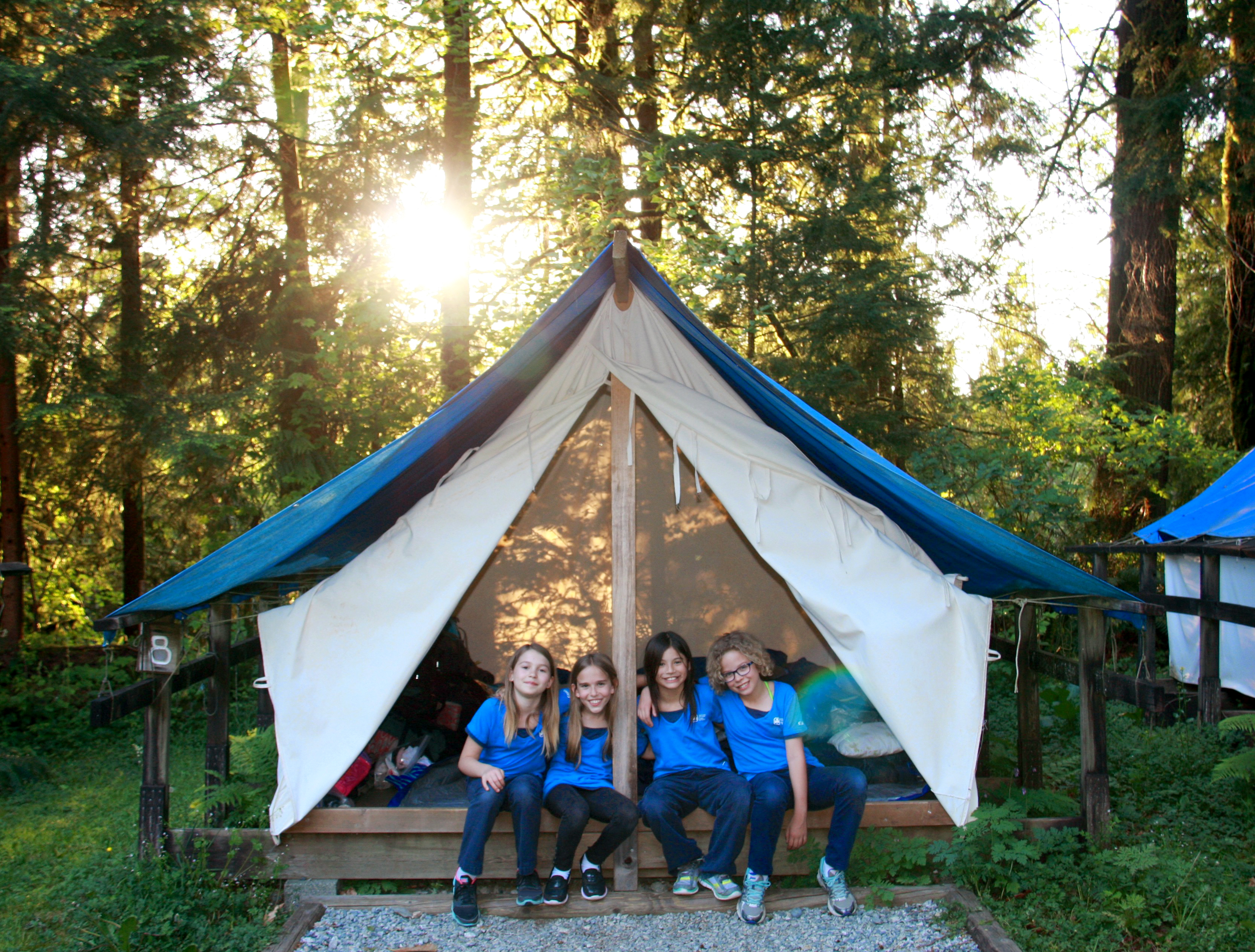 Girls sitting in a tent