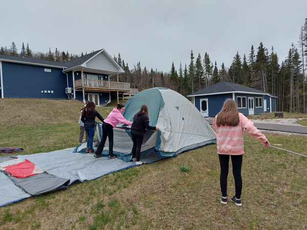 Girls pitching a tent
