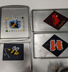 Purple Hat Trefoil Guild trying glass fusing.