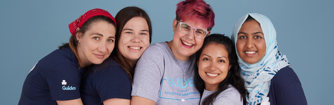 Four volunteers standing close