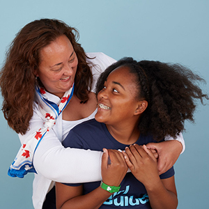 volunteer and girl laughing