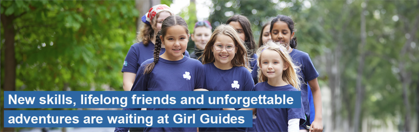 Group of girls and volunteers in unforms walking and smiling with their arms linked