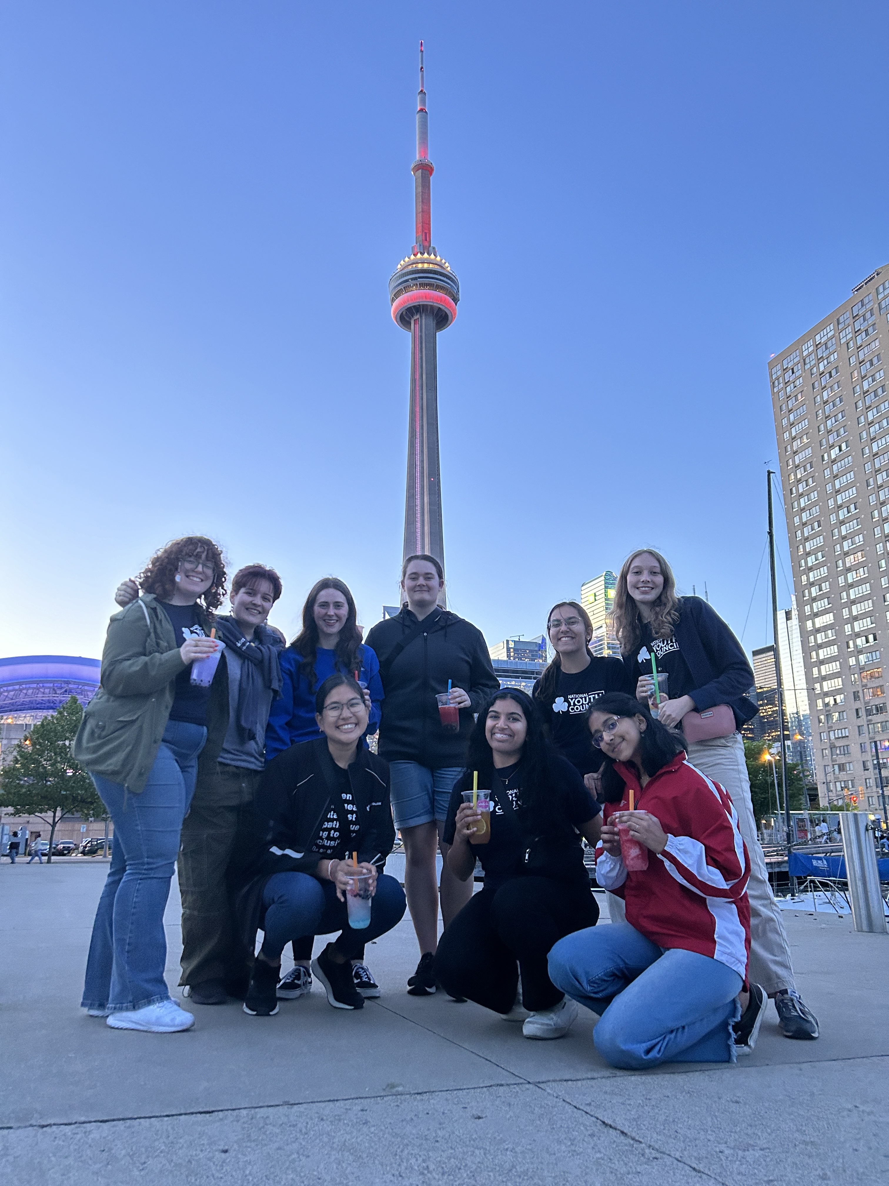 Guiding Ambassador and girls posing with CN tower, Toronto